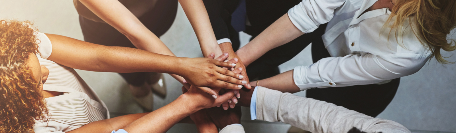 team members putting their hands together