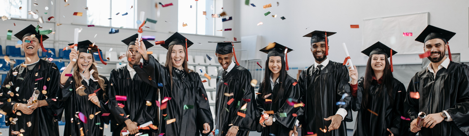 Group of graduates celebrating with confetti